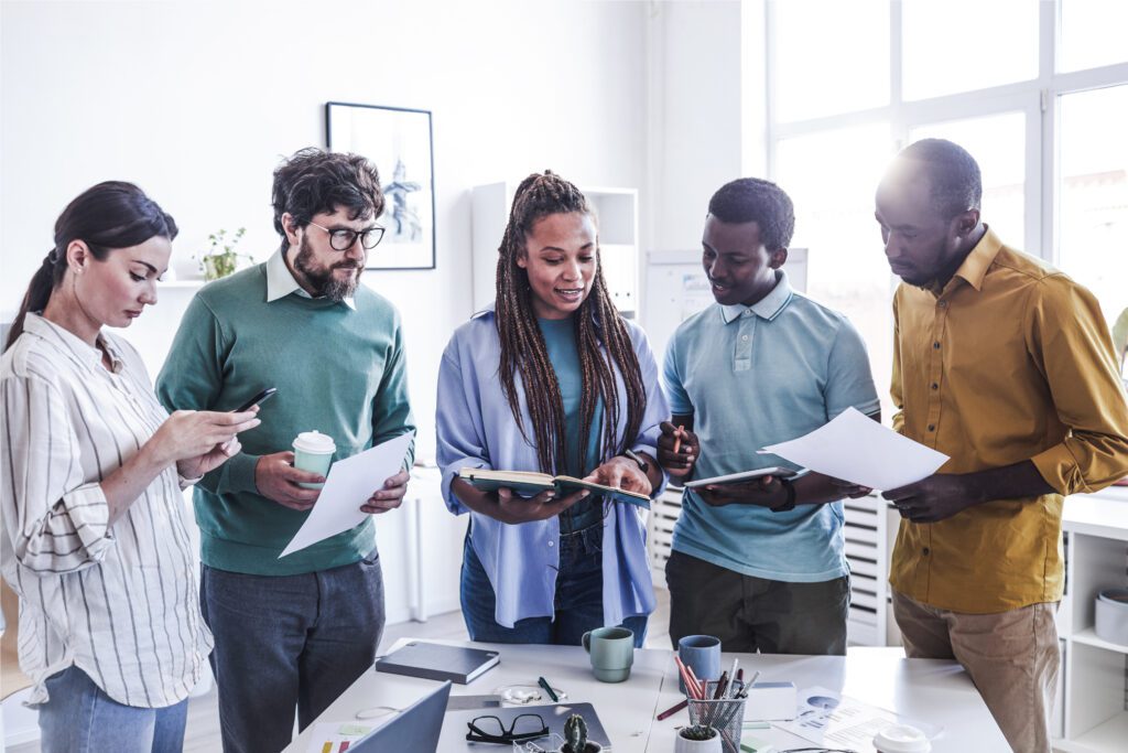 A team of people in a USA office with no privacy